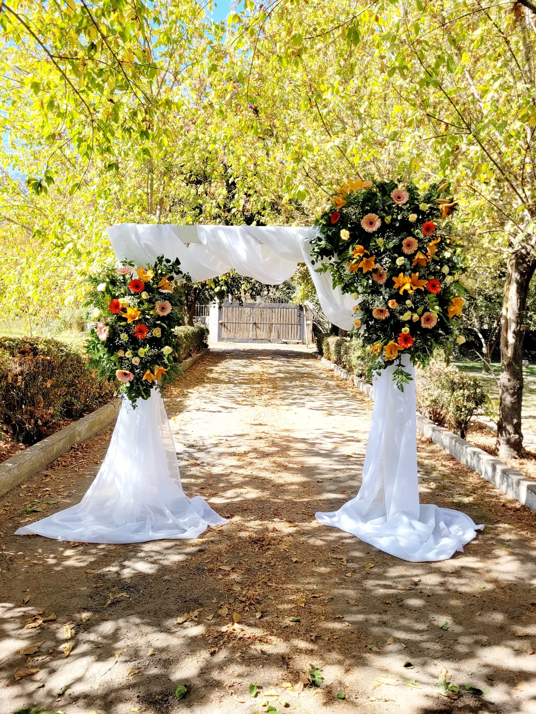 Camino ceremonial con lilium naranja y gerberas coral